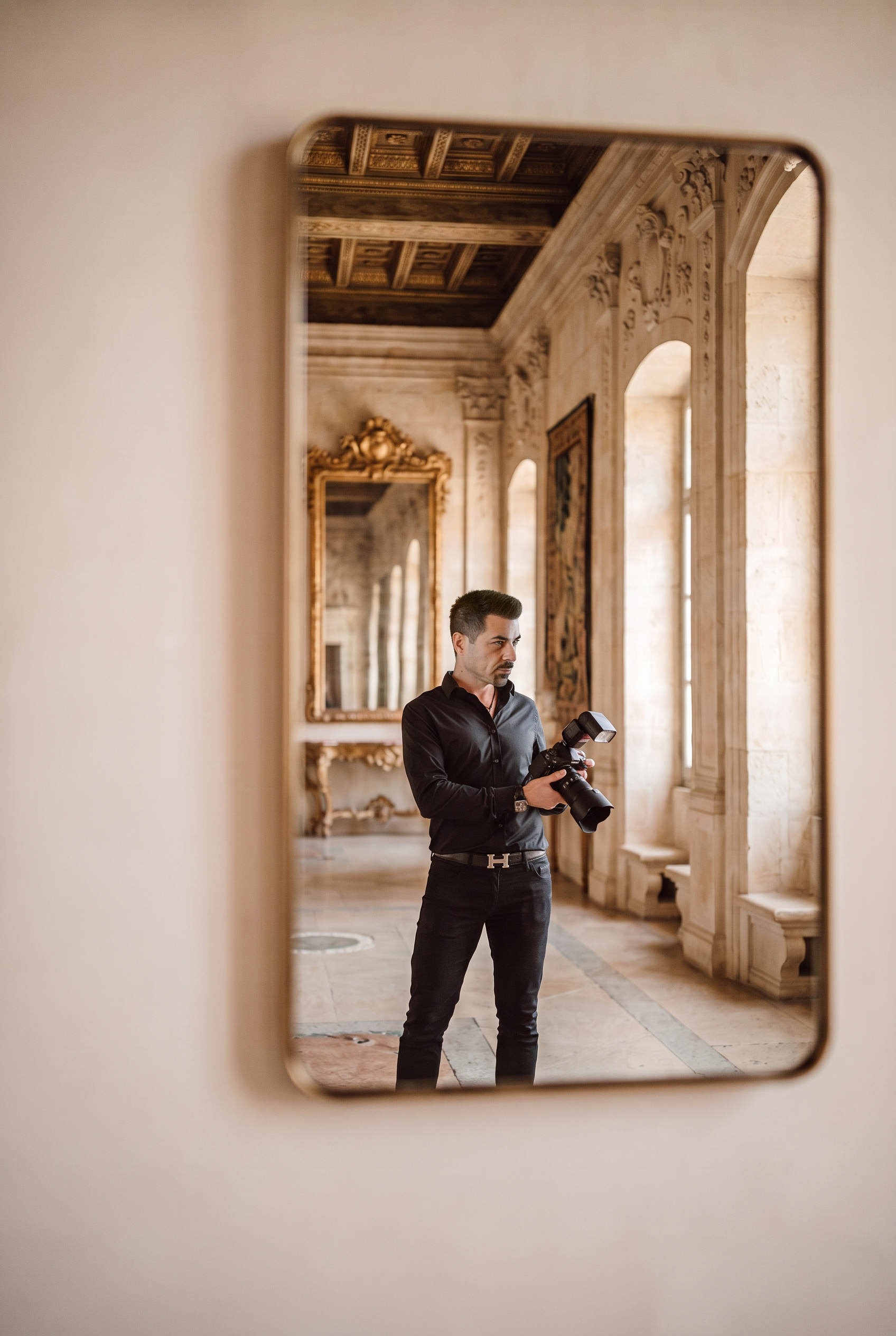 Plamen Blagoev reflected in a mirror inside an Italian castle venue, holding his camera